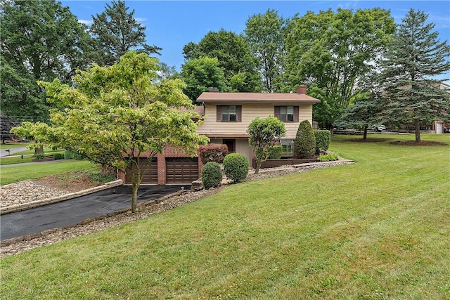 900 Tottenham Dr, Coraopolis, PA 15108 - view of front of property with asphalt driveway, a chimney, a front yard, and an attached garage