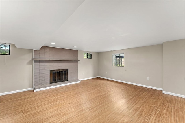900 Tottenham Dr, Coraopolis, PA 15108 - unfurnished living room featuring a brick fireplace, light wood finished floors, plenty of natural light, and recessed lighting