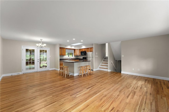 900 Tottenham Dr, Coraopolis, PA 15108 - unfurnished living room featuring light wood-type flooring, a chandelier, recessed lighting, and stairs