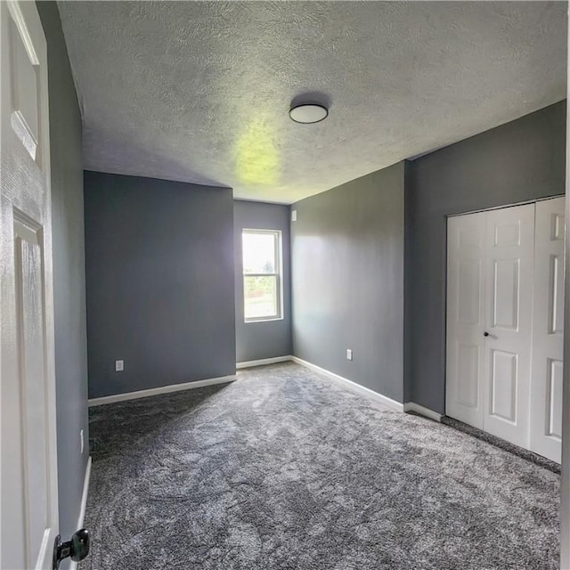 1914 Arlington Ave, Arlington, PA 15210 - unfurnished bedroom featuring carpet floors, a textured ceiling, and a closet