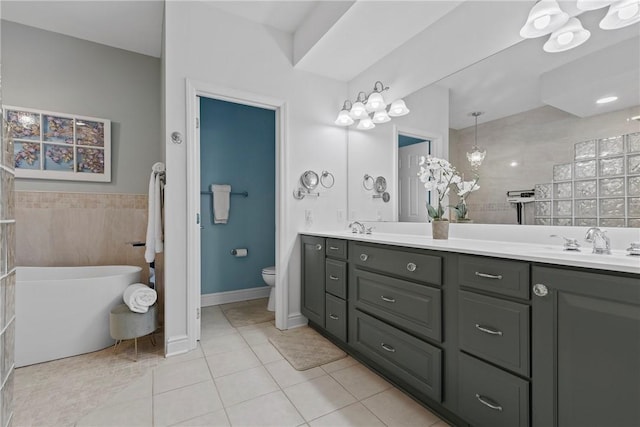 202 Providence Ct, Adams Twp, PA 16059 - bathroom featuring double vanity, a freestanding tub, and tile patterned flooring