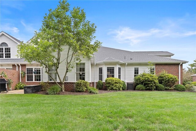 202 Providence Ct, Adams Twp, PA 16059 - rear view of house with a lawn, brick siding, and a shingled roof