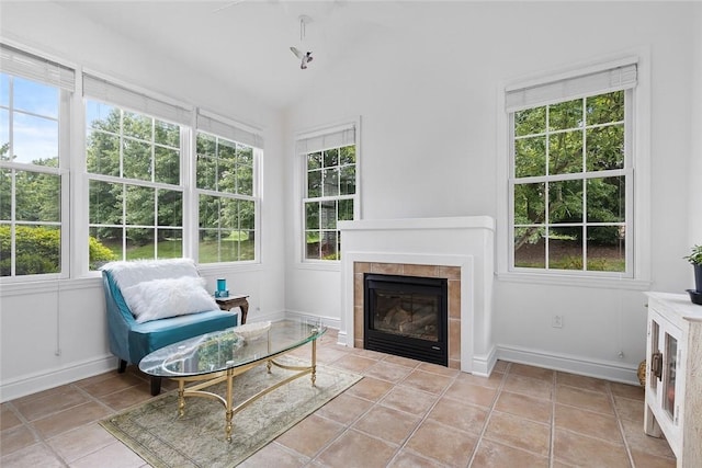 202 Providence Ct, Adams Twp, PA 16059 - living area with a tiled fireplace, light tile patterned floors, and vaulted ceiling