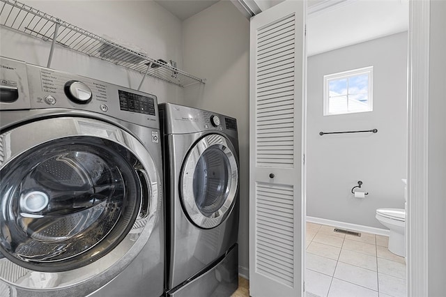 1009 Grey Fox Cir, Bridgeville, PA 15017 - laundry room with washer and dryer and light tile patterned floors
