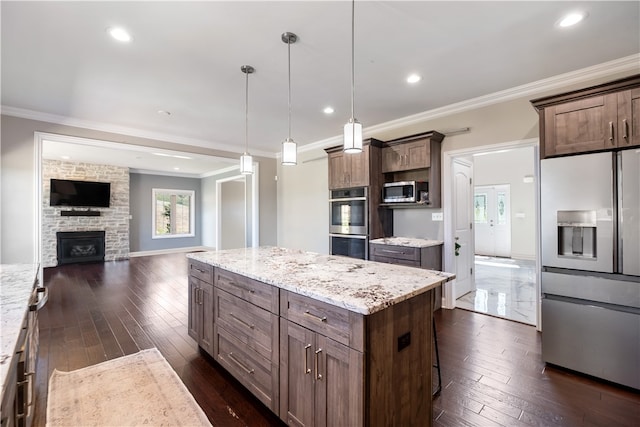 507 Saddlewood Dr, Peters Twp, PA 15367 - kitchen with appliances with stainless steel finishes, ornamental molding, dark wood-type flooring, a kitchen island, and open floor plan