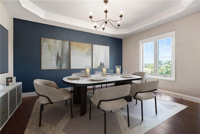 507 Saddlewood Dr, Peters Twp, PA 15367 - dining area featuring a raised ceiling, a chandelier, ornamental molding, and wood finished floors