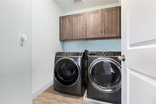 507 Saddlewood Dr, Peters Twp, PA 15367 - laundry area featuring cabinet space, washing machine and clothes dryer, and wood finished floors