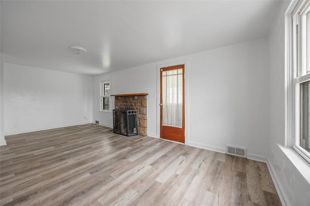 1 Core, City Of Washington, PA 15301 - unfurnished living room with plenty of natural light, wood finished floors, and a stone fireplace