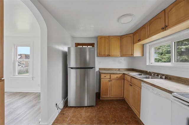 1 Core, City Of Washington, PA 15301 - kitchen with freestanding refrigerator, white dishwasher, arched walkways, stove, and light countertops