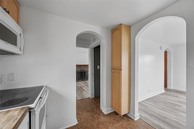 1 Core, City Of Washington, PA 15301 - kitchen with white appliances, arched walkways, dark tile patterned floors, and a fireplace