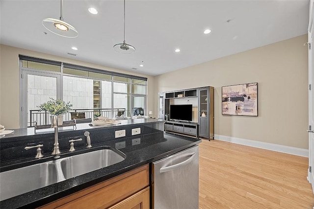 301 5th Unit 505, Downtown Pgh, PA 15222 - kitchen with dishwasher, light wood-type flooring, brown cabinetry, pendant lighting, and dark stone countertops