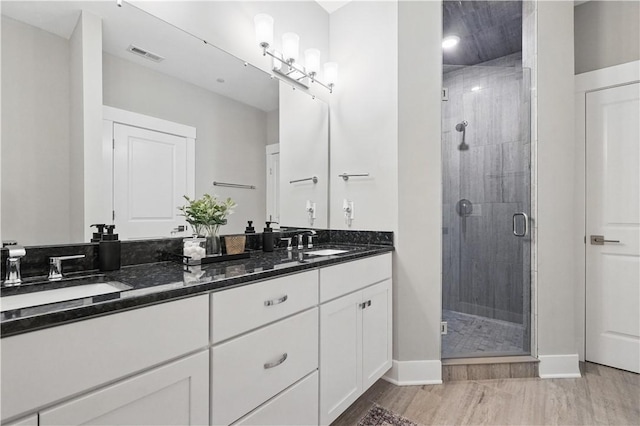 349 Azalea, Peters Twp, PA 15367 - bathroom featuring double vanity, a shower stall, and wood finished floors