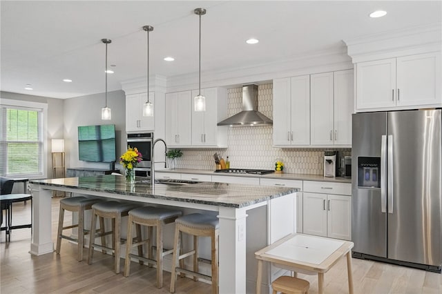349 Azalea, Peters Twp, PA 15367 - kitchen with appliances with stainless steel finishes, wall chimney exhaust hood, light wood-style flooring, dark stone countertops, and recessed lighting