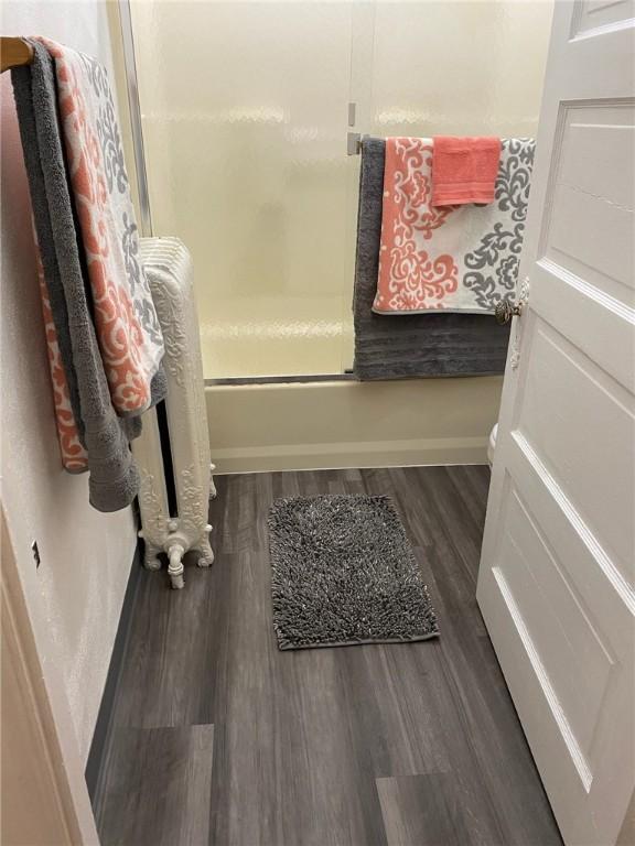 318 Mueller Ave, Crafton, PA 15205 - bathroom with wood finished floors and bath / shower combo with glass door