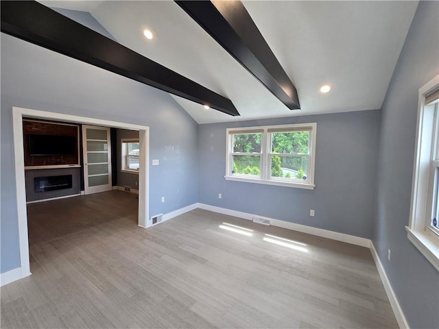 5303 Wickliff St, Lawrenceville, PA 15201 - unfurnished living room featuring wood finished floors, a glass covered fireplace, and recessed lighting