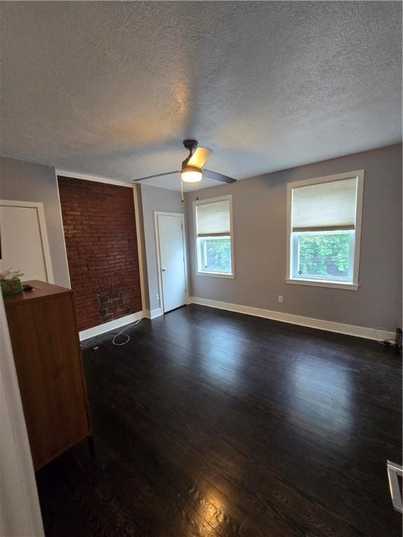 5303 Wickliff St, Lawrenceville, PA 15201 - unfurnished room featuring a textured ceiling, dark wood-style floors, healthy amount of natural light, and ceiling fan