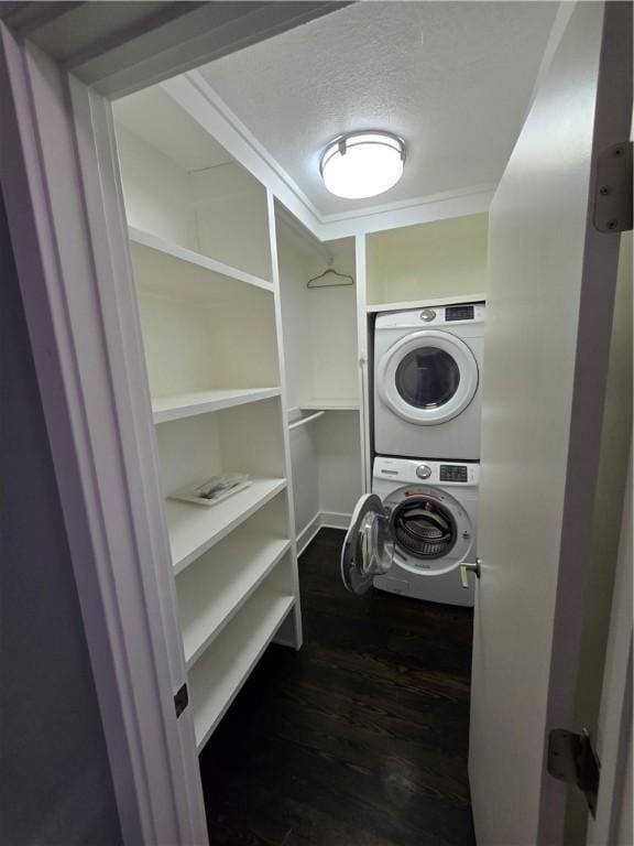 5303 Wickliff St, Lawrenceville, PA 15201 - laundry room with stacked washer / drying machine, a textured ceiling, dark wood-style floors, and ornamental molding