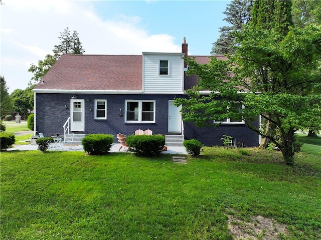 3715 Tuscarawas Rd, Brighton Twp, PA 15009 - view of front of house featuring entry steps, a front lawn, brick siding, and a chimney