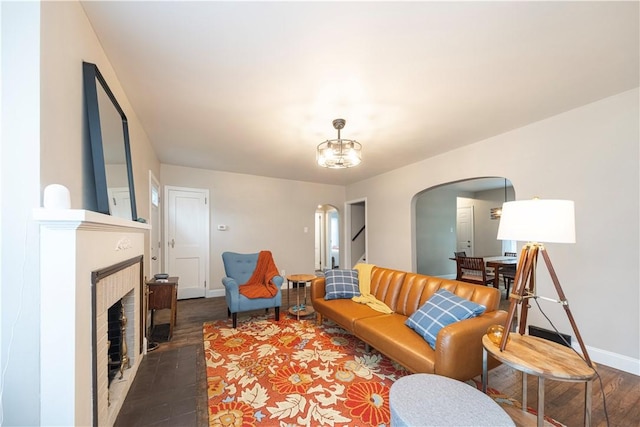 3715 Tuscarawas Rd, Brighton Twp, PA 15009 - living room featuring arched walkways, wood finished floors, and a fireplace