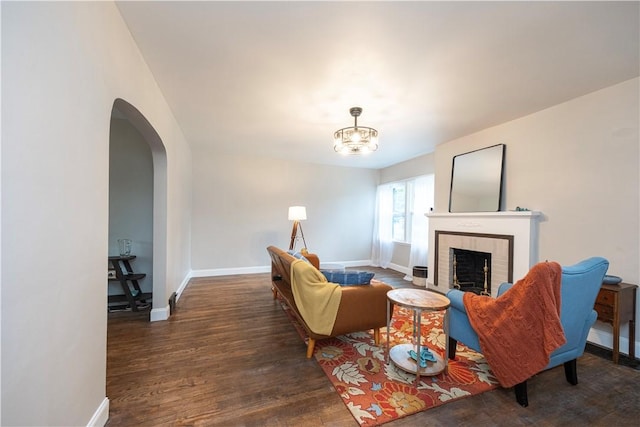 3715 Tuscarawas Rd, Brighton Twp, PA 15009 - living room featuring wood finished floors, a brick fireplace, arched walkways, and a chandelier
