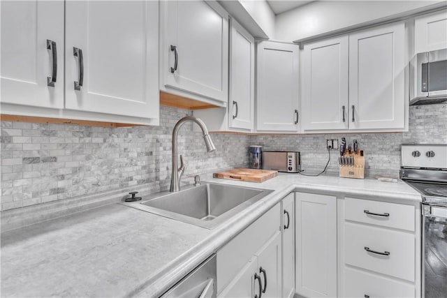 3616 Allendale Cir, Sheraden, PA 15204 - kitchen featuring appliances with stainless steel finishes, light countertops, tasteful backsplash, and white cabinets