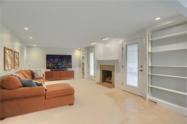 329 Oak Grove Ct, Mccandless, PA 15090 - living area with a fireplace with raised hearth, recessed lighting, built in features, and light tile patterned floors