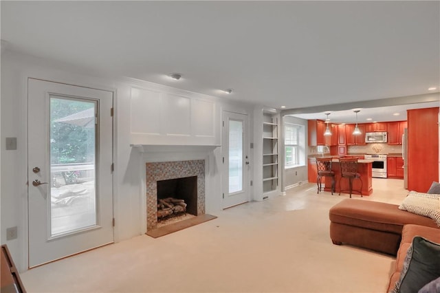 329 Oak Grove Ct, Mccandless, PA 15090 - living room with a fireplace with raised hearth, plenty of natural light, light carpet, and recessed lighting