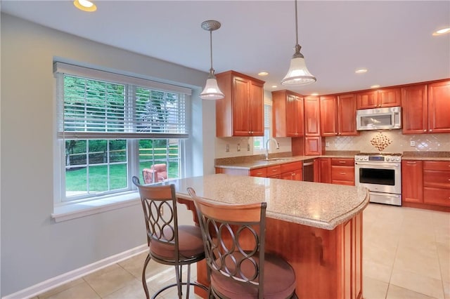 329 Oak Grove Ct, Mccandless, PA 15090 - kitchen featuring appliances with stainless steel finishes, healthy amount of natural light, light tile patterned floors, decorative backsplash, and recessed lighting