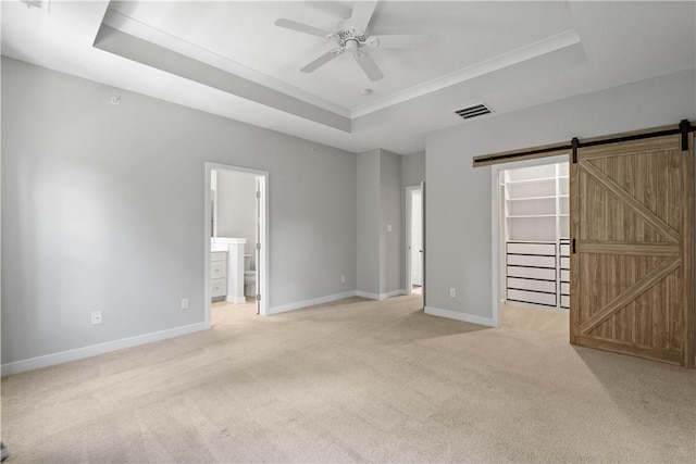 152 Cole Dr, Robinson Twp, PA 15136 - unfurnished bedroom with a raised ceiling, light carpet, a barn door, a walk in closet, and ensuite bath