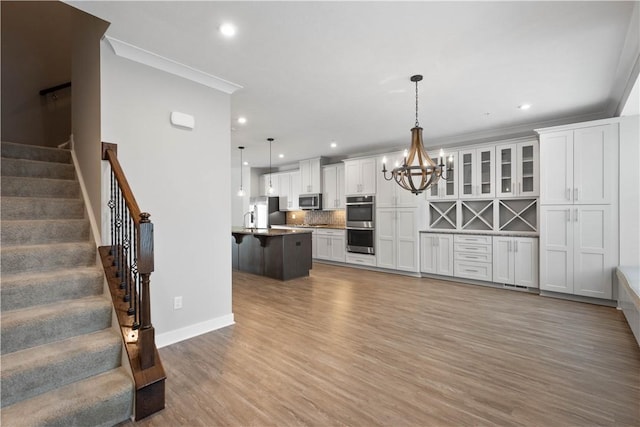 152 Cole Dr, Robinson Twp, PA 15136 - kitchen with appliances with stainless steel finishes, a breakfast bar, light wood-style flooring, a chandelier, and white cabinets