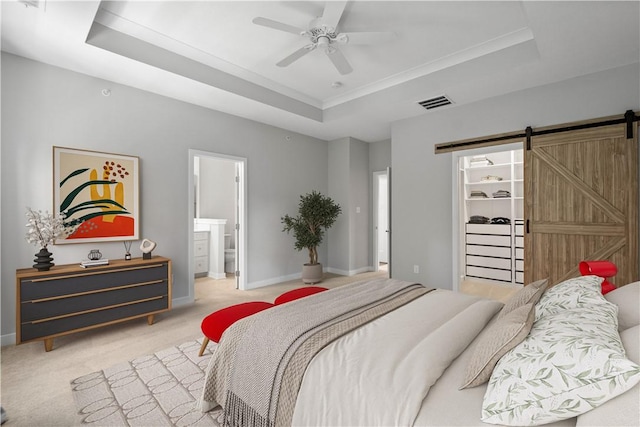 152 Cole Dr, Robinson Twp, PA 15136 - bedroom with a tray ceiling, a barn door, carpet, a walk in closet, and a ceiling fan
