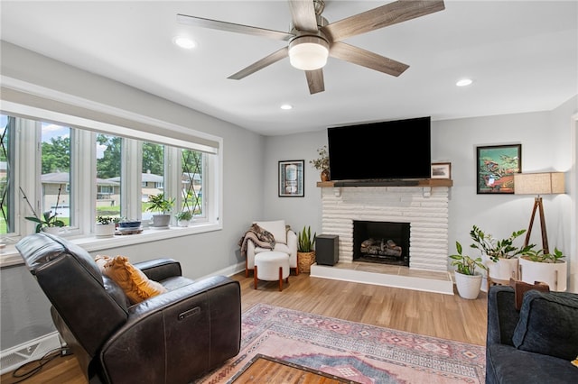 68 Cynthia Dr, Carnegie, PA 15106 - living room featuring a fireplace with raised hearth, wood finished floors, ceiling fan, and recessed lighting