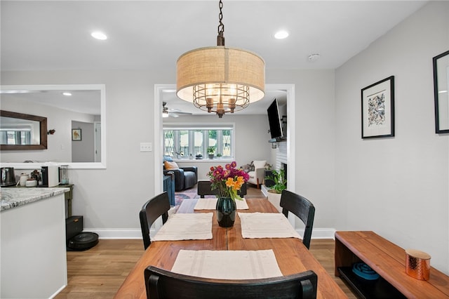 68 Cynthia Dr, Carnegie, PA 15106 - dining room with wood finished floors, ceiling fan, recessed lighting, a fireplace, and a chandelier