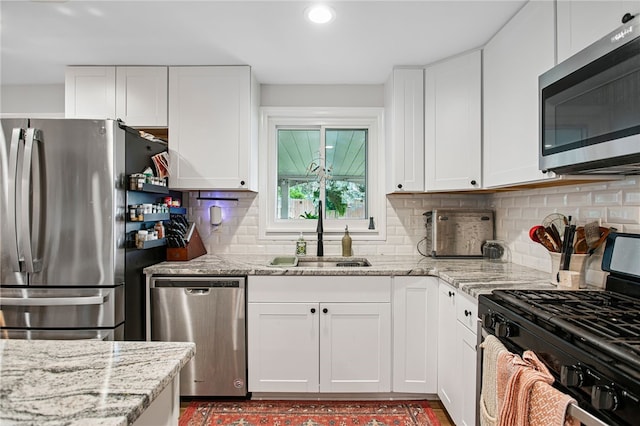 68 Cynthia Dr, Carnegie, PA 15106 - kitchen with appliances with stainless steel finishes, white cabinetry, light stone counters, recessed lighting, and decorative backsplash