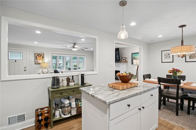 68 Cynthia Dr, Carnegie, PA 15106 - kitchen featuring light wood finished floors, white cabinets, recessed lighting, a kitchen island, and decorative light fixtures