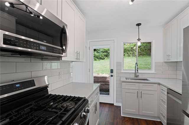 334 Shaler St, Mt Washington, PA 15211 - kitchen with appliances with stainless steel finishes, dark wood-style flooring, light countertops, tasteful backsplash, and white cabinetry