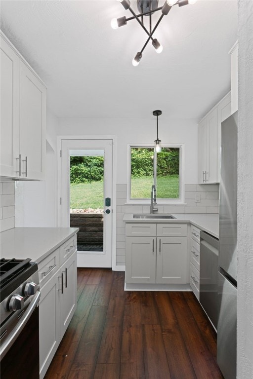 334 Shaler St, Mt Washington, PA 15211 - kitchen with appliances with stainless steel finishes, light countertops, a chandelier, tasteful backsplash, and dark wood-style floors