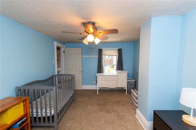 901 Alexander St, Shaler, PA 15116 - carpeted bedroom featuring a ceiling fan, a crib, and a textured ceiling