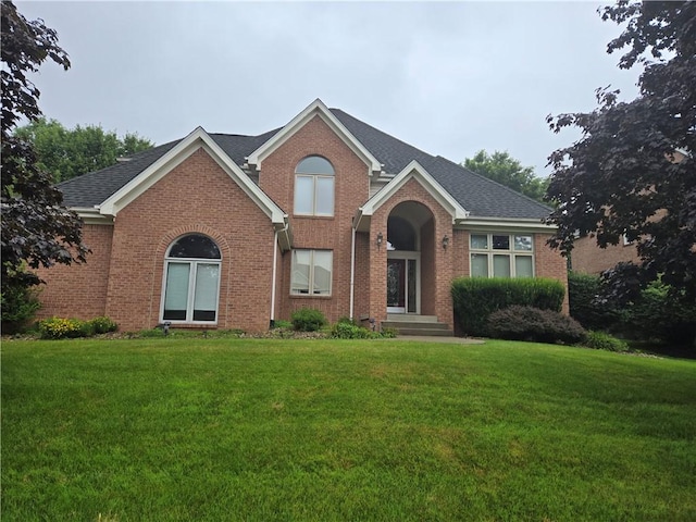 170 Pinehurst Dr, Cranberry Twp, PA 16066 - view of front facade featuring brick siding, a front yard, and a shingled roof