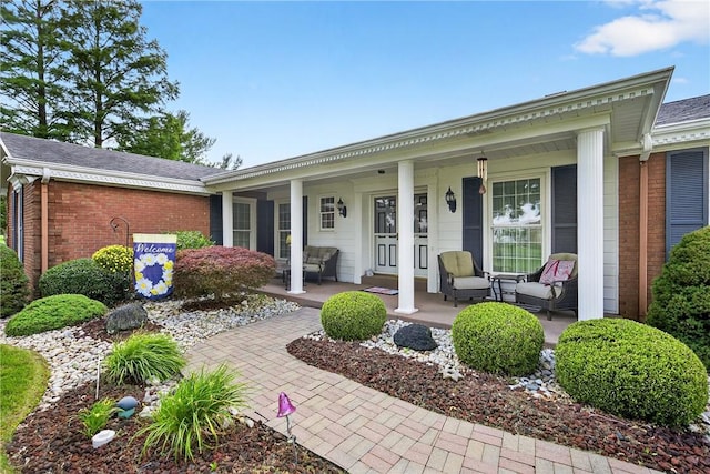 566 Ridgeview Rd, East Huntingdon, PA 15666 - property entrance with covered porch, brick siding, and a shingled roof