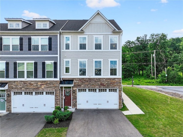 124 Rivulet Pl, Jackson Twp, PA 16063 - view of property featuring stone siding, driveway, an attached garage, and a front yard