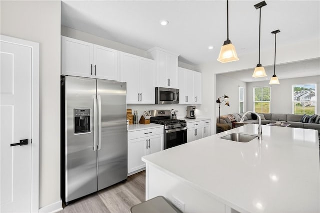 124 Rivulet Pl, Jackson Twp, PA 16063 - kitchen with appliances with stainless steel finishes, white cabinets, light wood finished floors, open floor plan, and light countertops