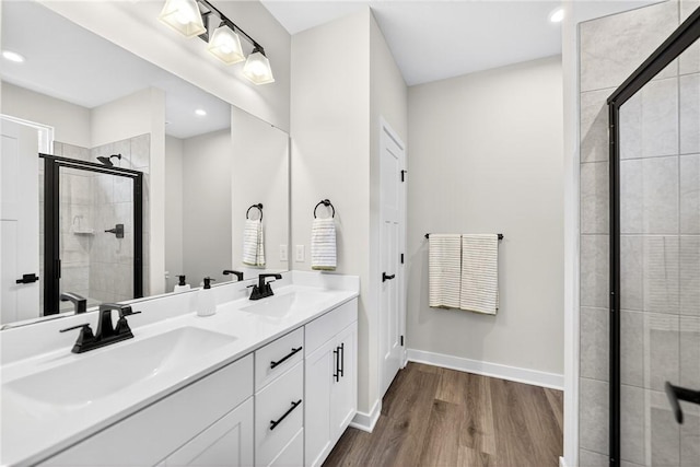 124 Rivulet Pl, Jackson Twp, PA 16063 - bathroom with wood finished floors, a stall shower, double vanity, and recessed lighting