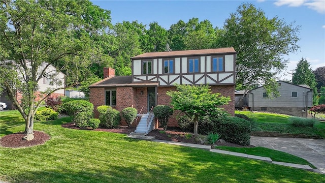 102 Barnwood Ln, Ross Twp, PA 15237 - tudor house featuring a front lawn, brick siding, and a chimney