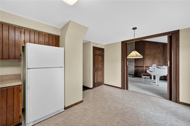 102 Barnwood Ln, Ross Twp, PA 15237 - kitchen featuring freestanding refrigerator, light colored carpet, light countertops, and hanging light fixtures