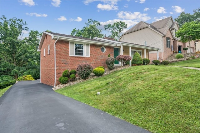 12 Lynmar Dr, Shaler, PA 15209 - traditional-style house with brick siding, a front yard, and a chimney