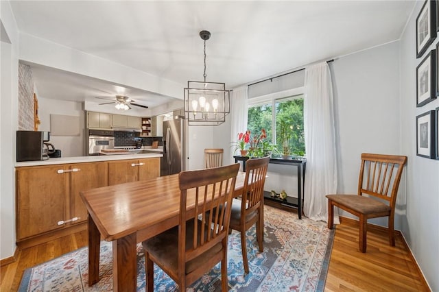 12 Lynmar Dr, Shaler, PA 15209 - dining room with light wood-type flooring, a chandelier, and ceiling fan