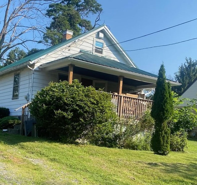 1920 Cliff St, Coraopolis, PA 15108 - view of side of home featuring a chimney, a yard, a metal roof, and a standing seam roof