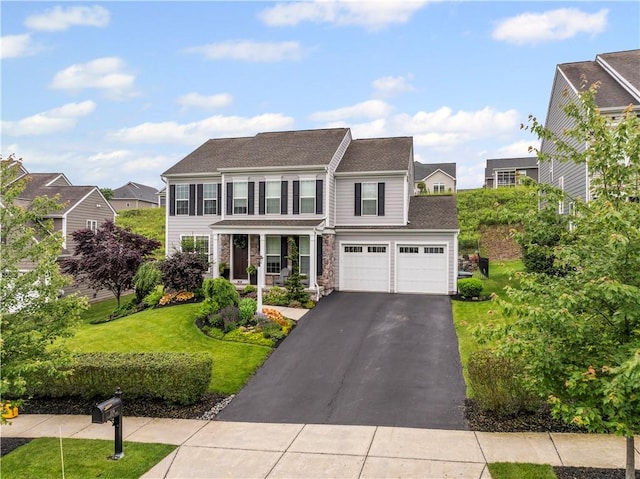 109 Overbrook Dr, Cranberry Twp, PA 16066 - colonial home with driveway, an attached garage, a front yard, stone siding, and covered porch