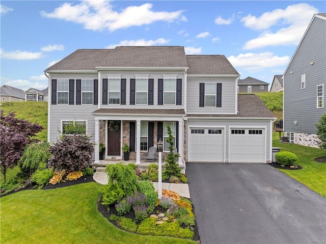 109 Overbrook Dr, Cranberry Twp, PA 16066 - colonial house with asphalt driveway, a porch, a front lawn, a garage, and roof with shingles